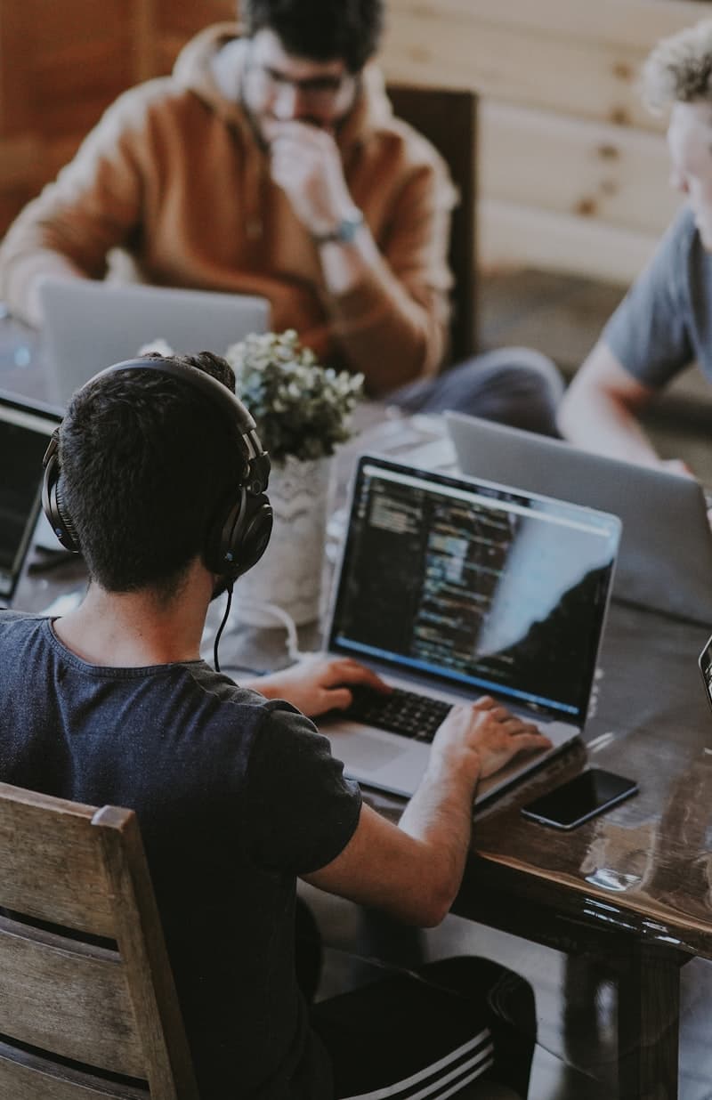 Developers working side by side at laptops
