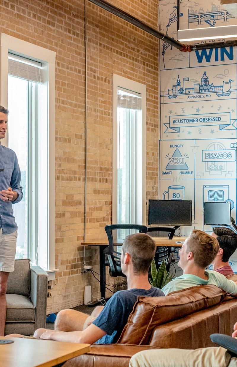 Founder presenting to a small team in a loft office