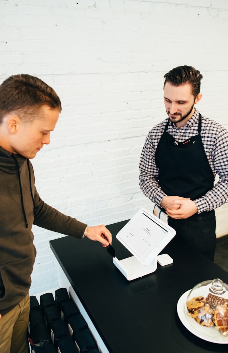 Small business owner serving a customer at the counter