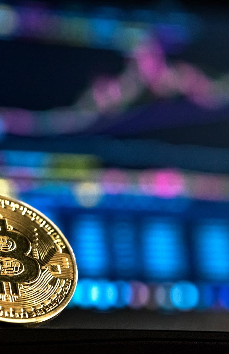 Gold bitcoin against a trading chart