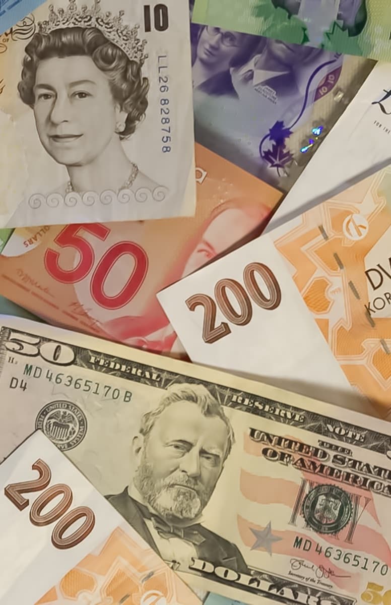 Banknotes in several currencies spread out