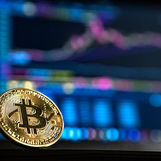 Gold bitcoin against a trading chart