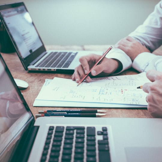 Advisors reviewing figures at a laptop