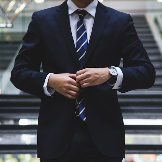 Executive in a suit adjusting his jacket