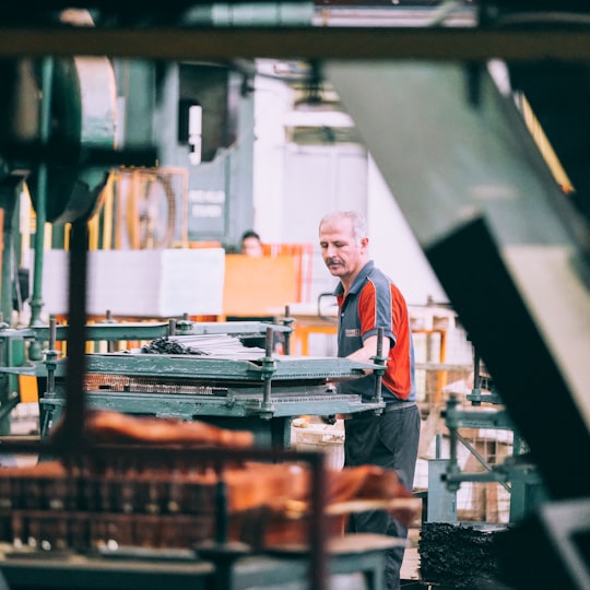 Machine operator working on industrial equipment in a factory
