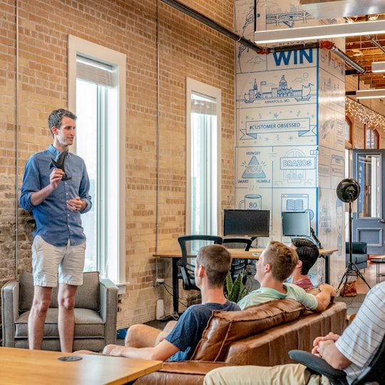 Founder presenting to a small team in a loft office